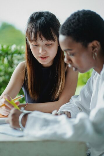 Person studying CFA curriculum books and practice questions diligently