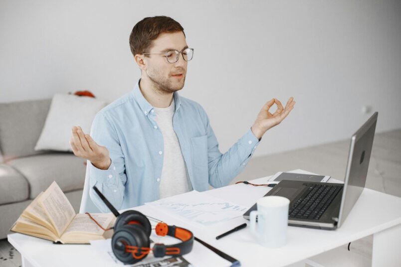 Person engaging in relaxing activities like yoga, reading, or spending time in nature